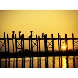 : People Walking across the Ubein Bridge at Sunset in Mandalay, Burma 