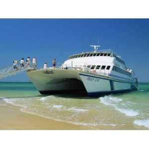 Tourists Boarding Large Catamaran on Beach Near Rockhampton 