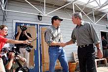 President George W. Bush and Texas Governor Rick Perry shake hands 